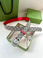 Gucci GG canvas belt with red trim and silver double-G buckle, looped