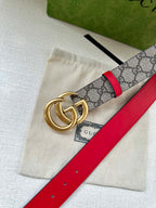 Gucci GG canvas belt with red leather edge and gold double-G buckle, angled