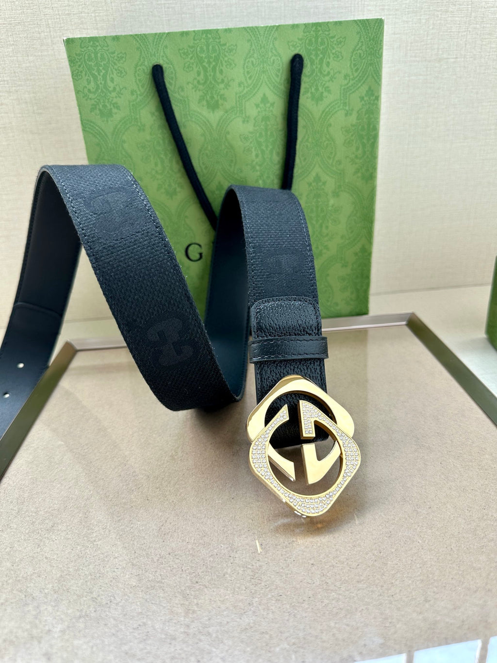 Dark navy leather belt with gold-tone GG buckle and strap with end tab