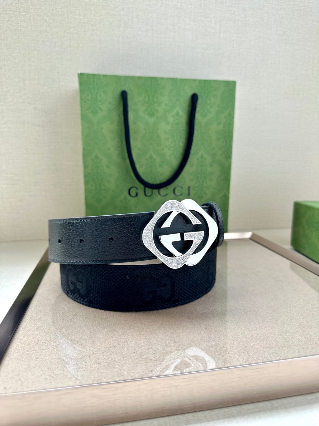 Dark navy leather Gucci belt with silver GG logo buckle on the front