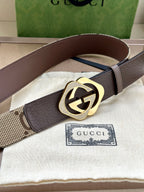 Gucci belt with dark brown leather strap and gold-tone circular GG buckle.