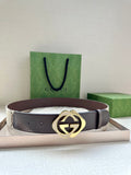 Gucci belt, brown leather strap, gold-tone GG logo buckle.