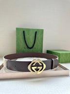 Gucci belt, brown leather strap, gold-tone GG logo buckle.