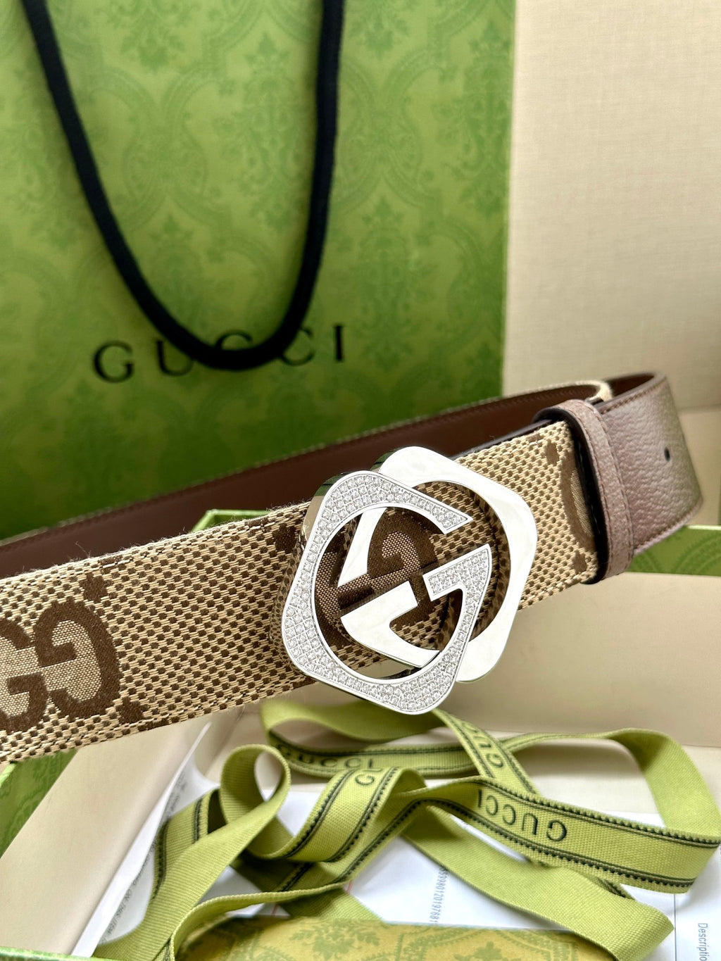 Gucci belt: beige GG canvas strap with silver-tone GG logo buckle.