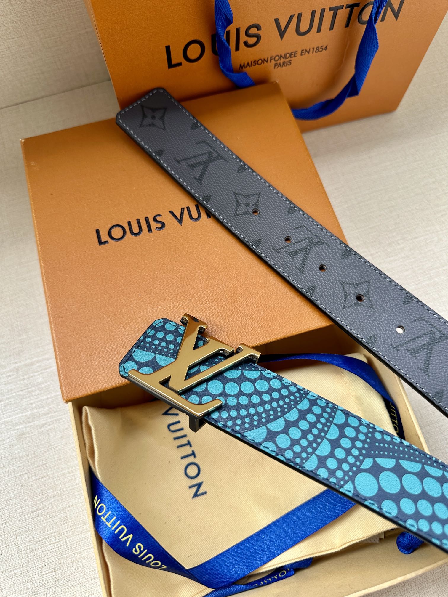 Louis Vuitton belt with turquoise dotted strap, LV gold buckle, dark gray strap keeper