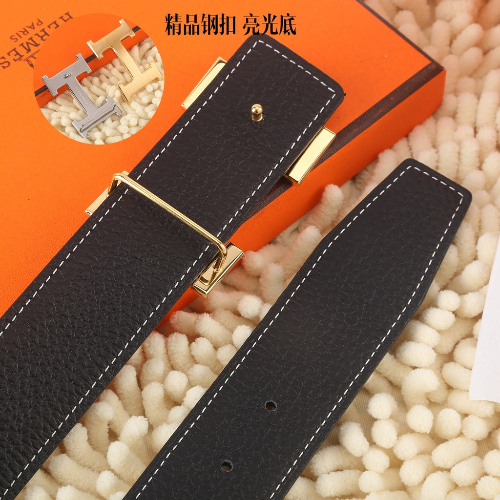 Black leather belt, gold-tone buckle, stitched keepers with holes