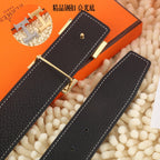 Black leather belt, gold-tone buckle, stitched keepers with holes