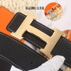 Black leather belt, gold-tone buckle, textured grain, close-up