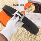 Black leather belt, silver-tone buckle, stitched edges, flat lay