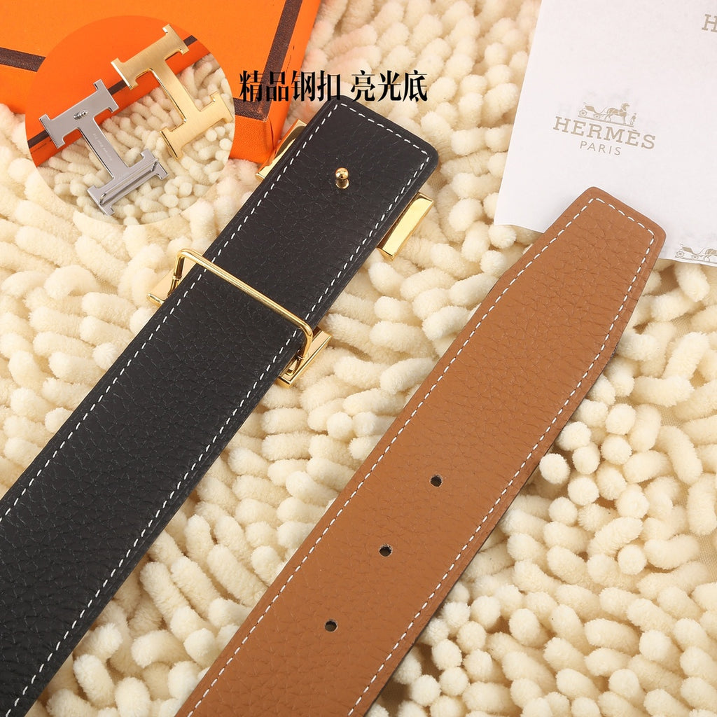 Hermes belt showing black and tan-brown leather straps with gold-tone buckle hardware
