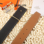 Hermes belt showing black and tan-brown leather straps with gold-tone buckle hardware