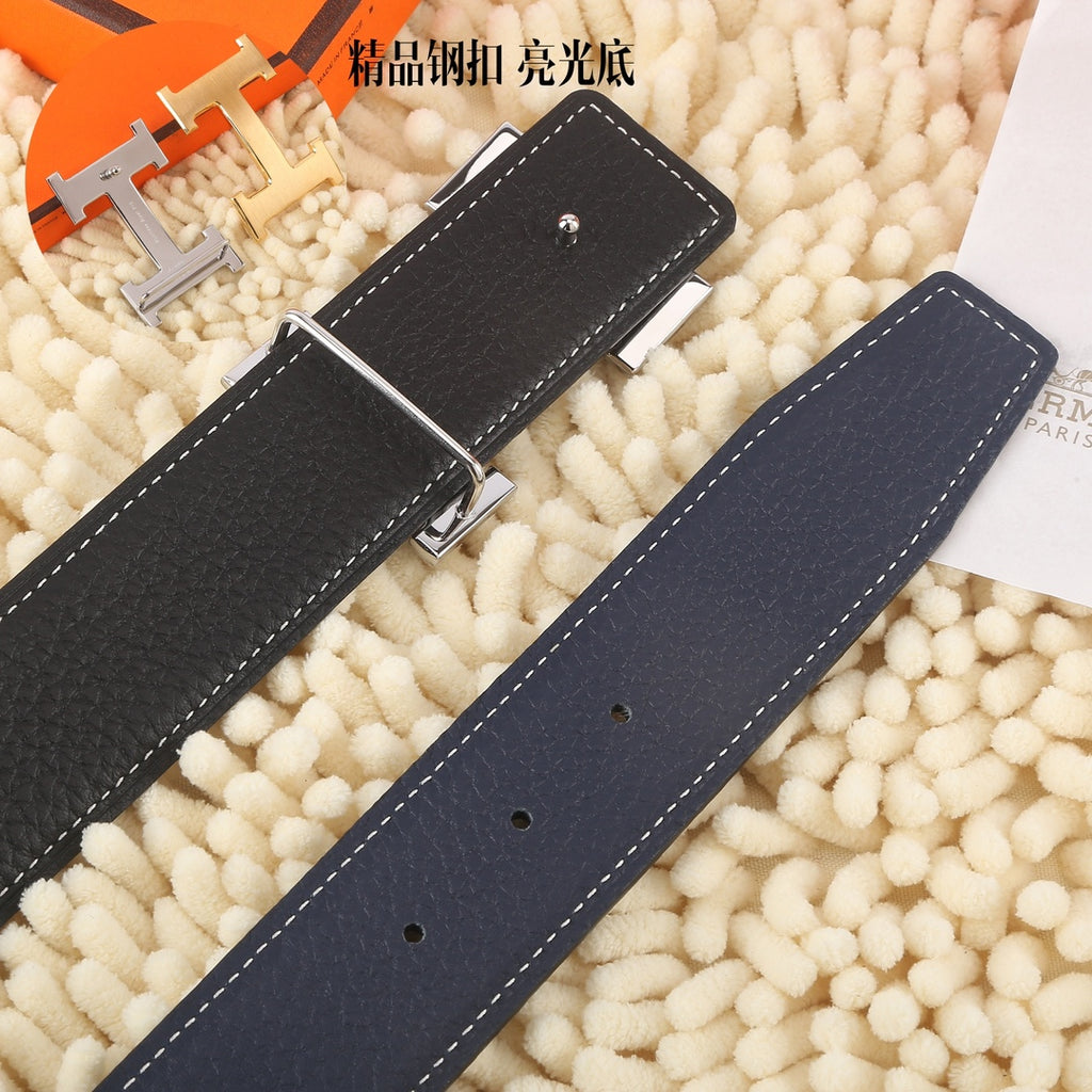 Navy leather belt with silver buckle hardware and punched adjustment holes.
