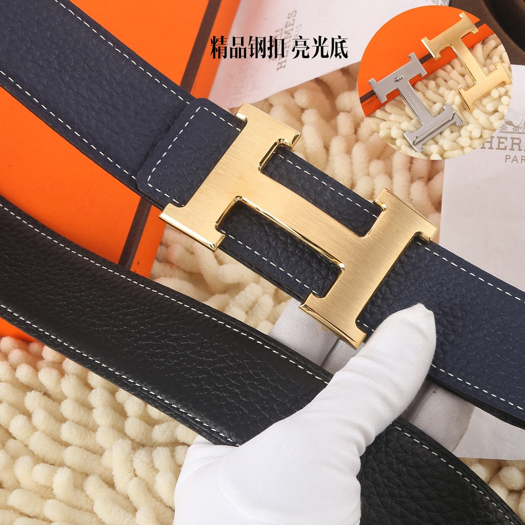 Navy leather belt close-up: gold-toned rectangular buckle with stitched detail.