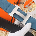 Blue pebbled leather belt close-up with silver-tone buckle, keeper, and contrast stitching