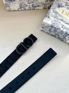 Dark blue fabric belt with repeating logo pattern and multiple adjustment holes