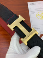Black leather belt close-up with gold-tone H buckle and red edge stitching.