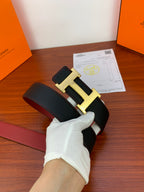 Hermes reversible leather belt, angled view black strap with gold-tone H buckle