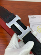 Hermes reversible leather belt, close-up black textured strap with silver-tone H buckle