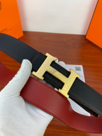 Hermes reversible leather belt, close-up black strap with gold-tone H buckle