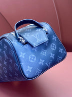 Louis Vuitton monogram bag in blue with top handle and front leather tab