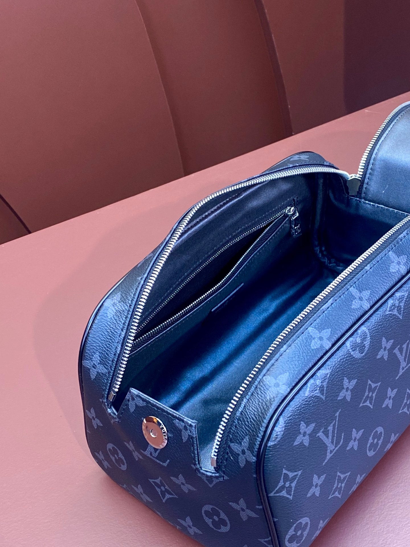 Louis Vuitton monogram bag in blue with open zip and visible interior lining