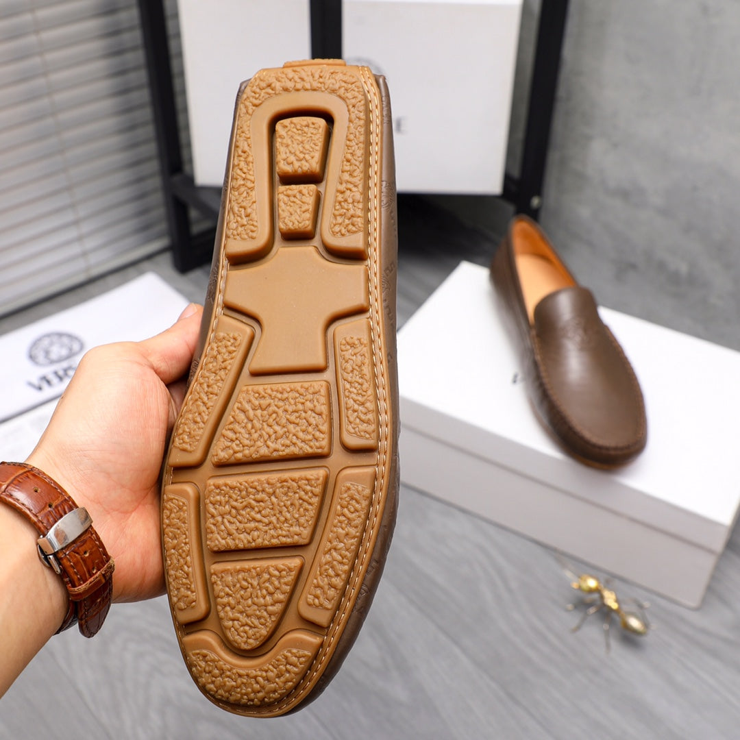 Versace brown leather loafer outsole close-up with textured tread pattern