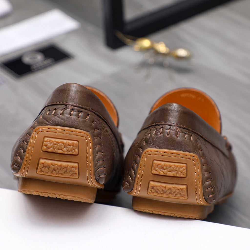 Versace brown leather loafers with tan heel backing and embossed strap detail