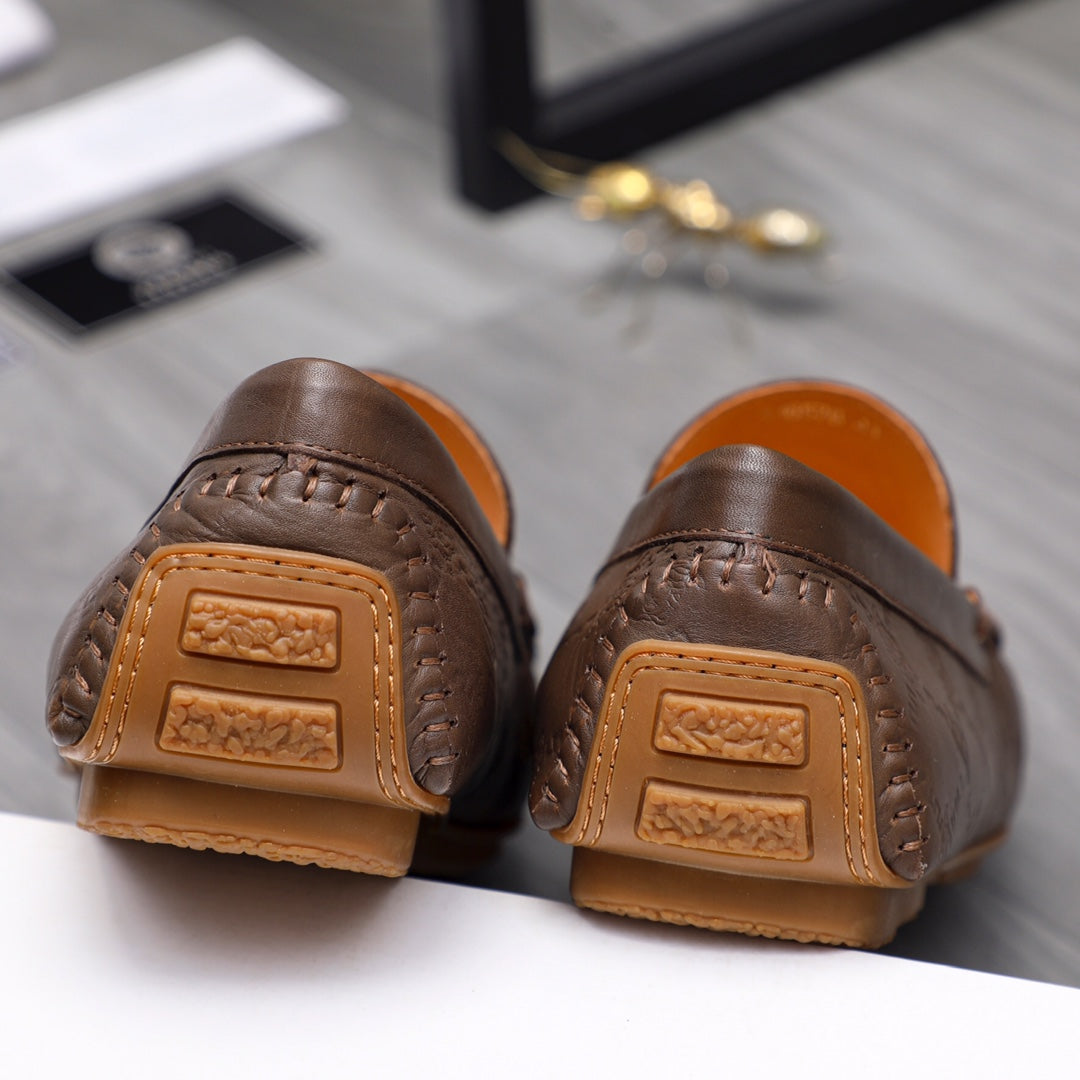 Versace brown leather loafers with tan heel backing and embossed strap detail