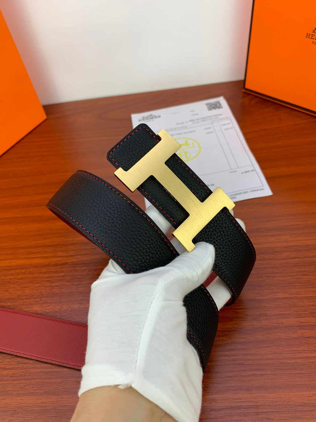 Black leather belt with gold-tone H buckle and keeper strap