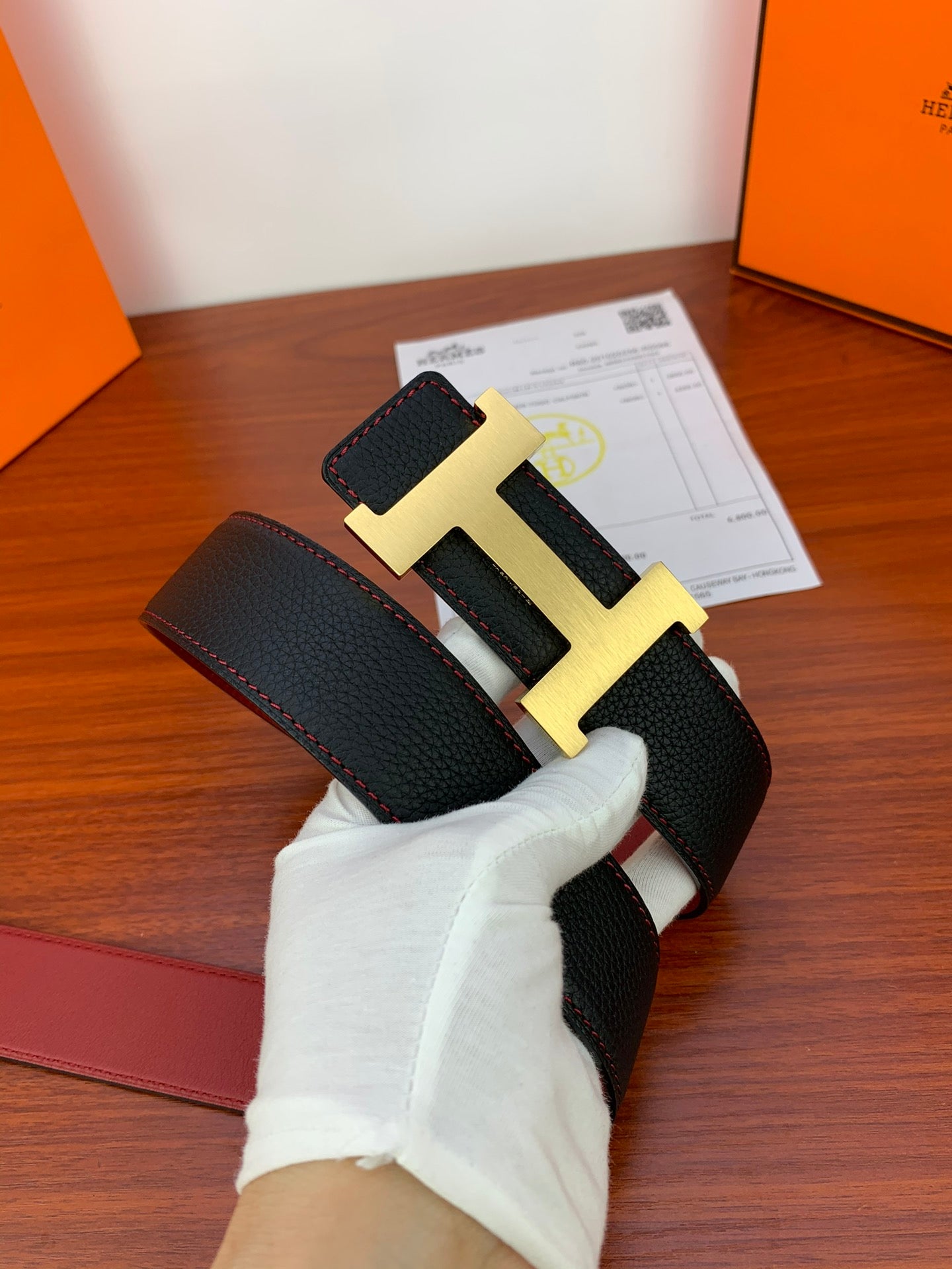 Black leather belt with gold-tone H buckle and keeper strap