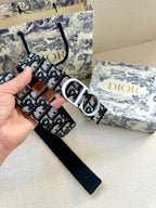 Dior belt held up, showing monogram webbing and silver double-D buckle