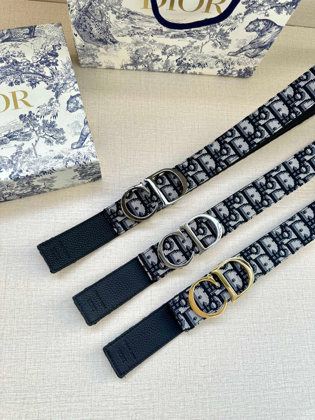 Dior belt set: monogram webbing with silver buckle and another with gold-tone buckle