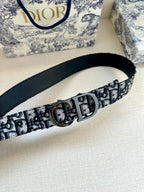 Dior belt with navy leather backing, repeating monogram webbing, and silver round buckle