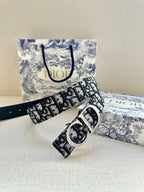 Dior belt with logo print strap and silver-tone buckle; strap ends visible.