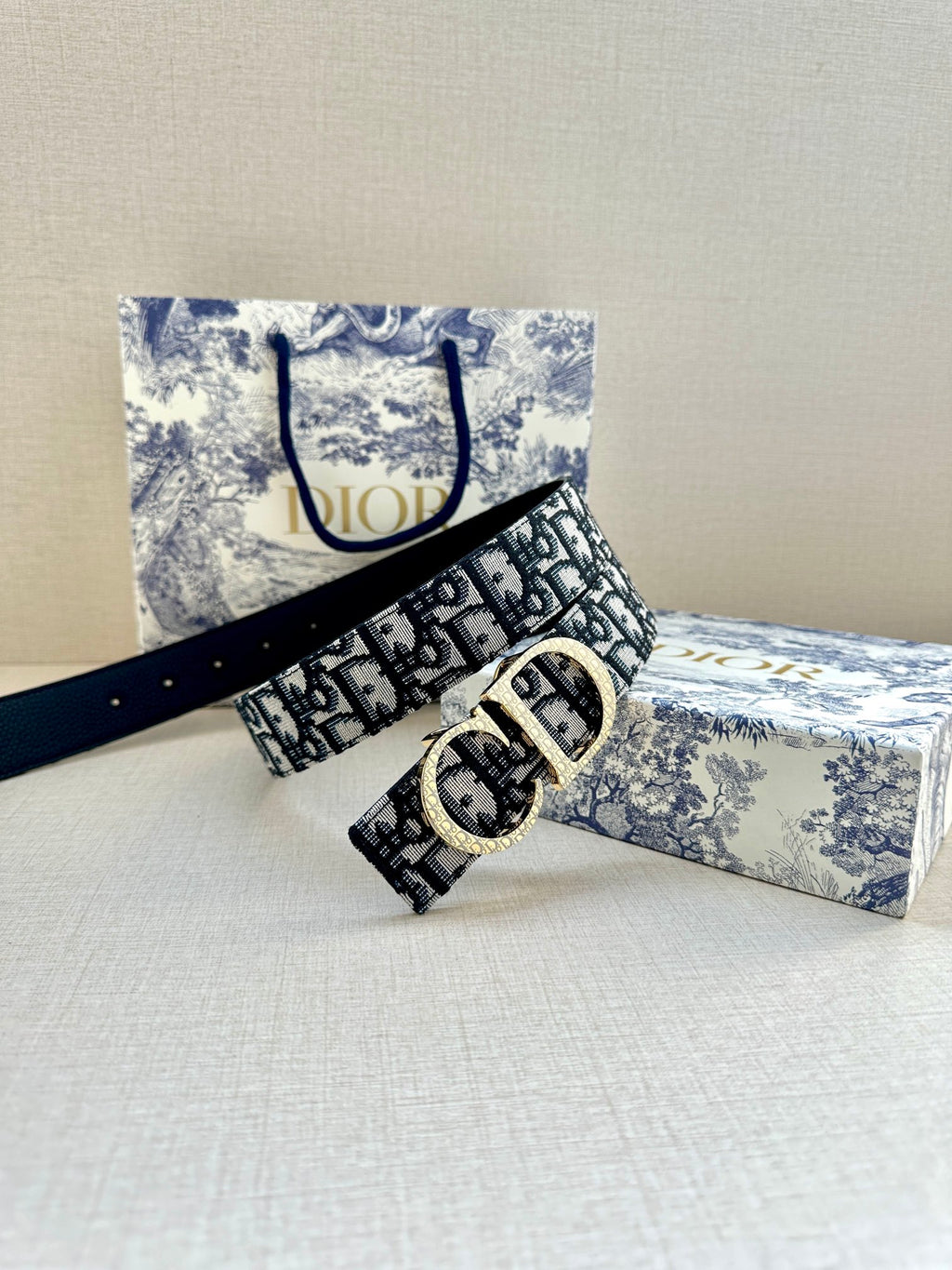 Dior belt with dark navy/black pattern, gold double-ring buckle