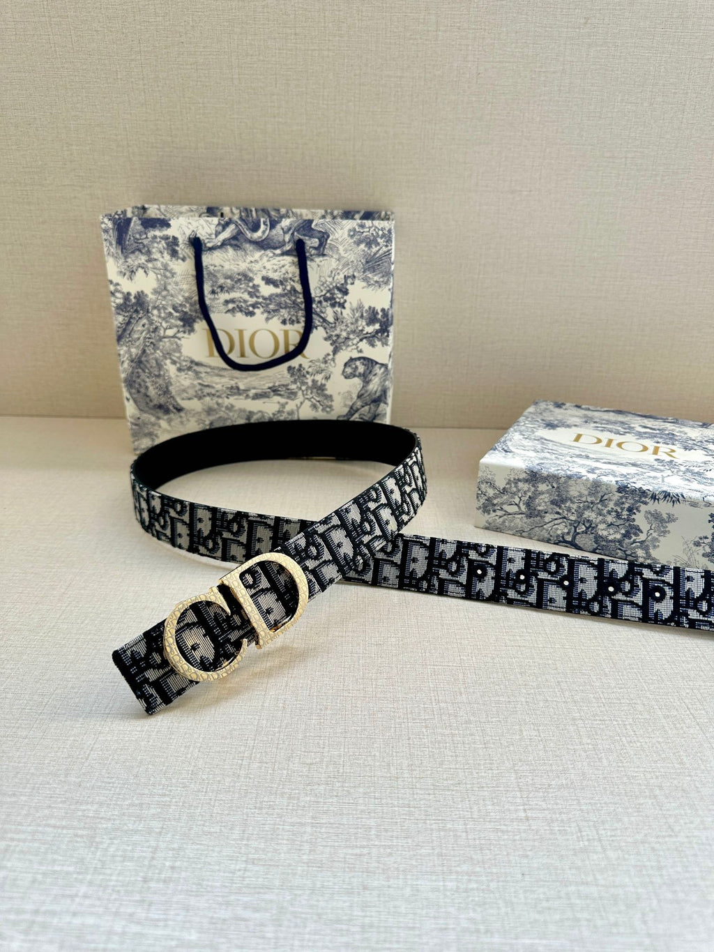 Dior belt with dark navy/black pattern, gold buckle and adjustable strap end