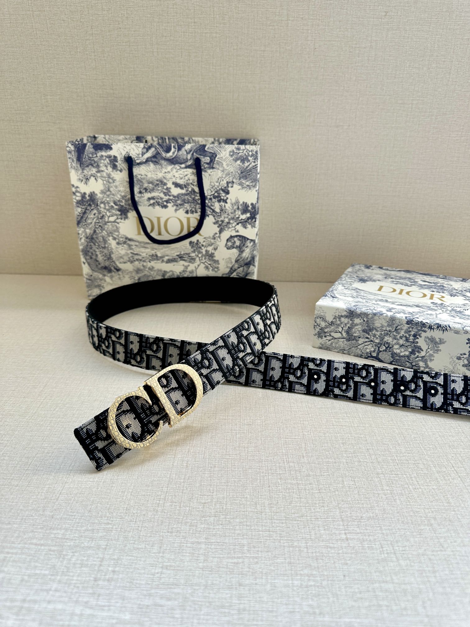 Dior belt with dark navy/black pattern, gold buckle and adjustable strap end