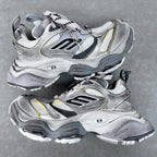 Balenciaga unisex sneakers in silver with black overlays, neon yellow accents, and laces.