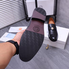 Versace black loafer outsole with geometric tread pattern, held in hand