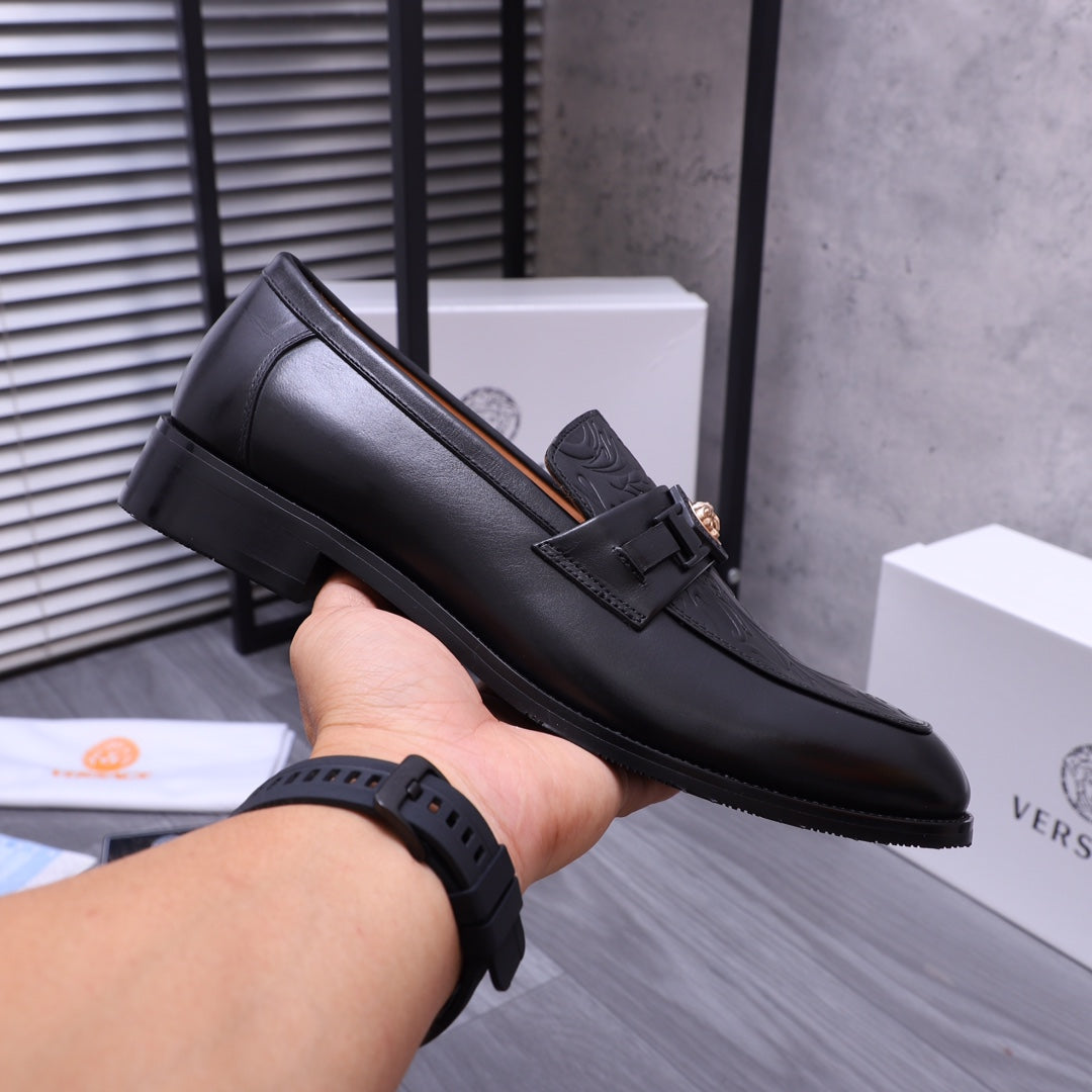 Versace black leather loafer with buckle strap and embossed upper, side view