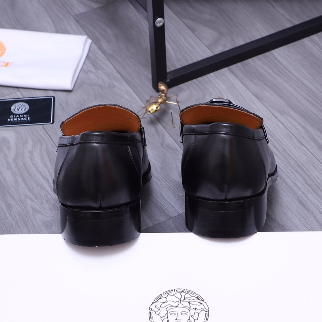 Back view of black Versace loafers pair with cushioned heels