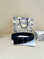 Black Dior belt with CD buckle and wide strap, centered on cloth.