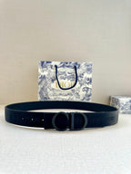 Dior belt with black fabric strap and large CD buckle, front view.