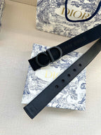 Black Dior belt with oversized CD buckle and adjustable holes, angled view.