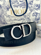 Dior belt close-up with dark strap and silver CD buckle