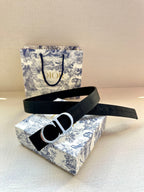 Navy belt with silver CD buckle, flat lay view