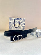 Navy belt with silver CD buckle centered on strap