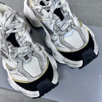 Unisex Balenciaga sneakers pair close-up, silver mesh upper with gold accents and black heel