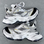 Unisex Balenciaga sneakers, silver with gold accents, lace-up, chunky black tread sole