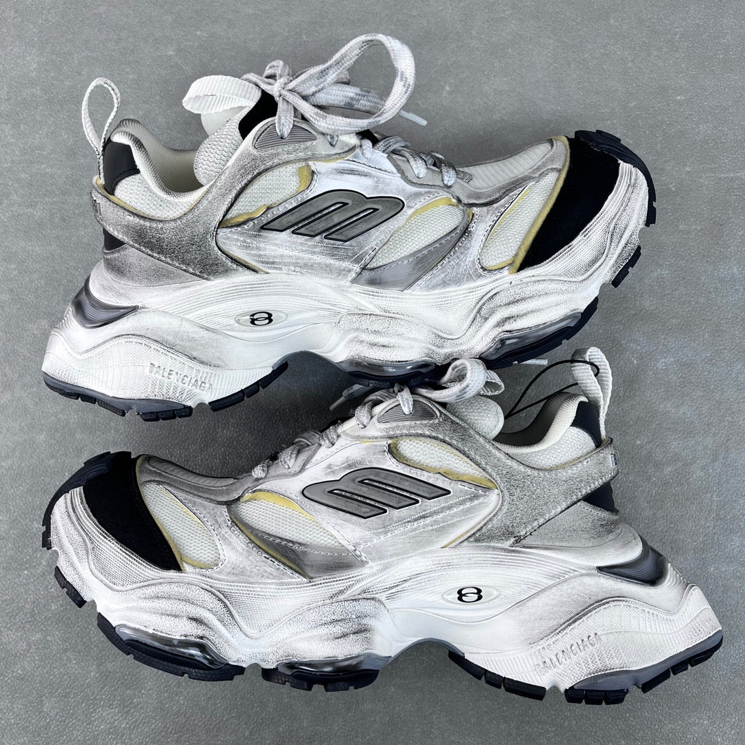 Unisex Balenciaga sneakers, silver with gold accents, lace-up, chunky black tread sole